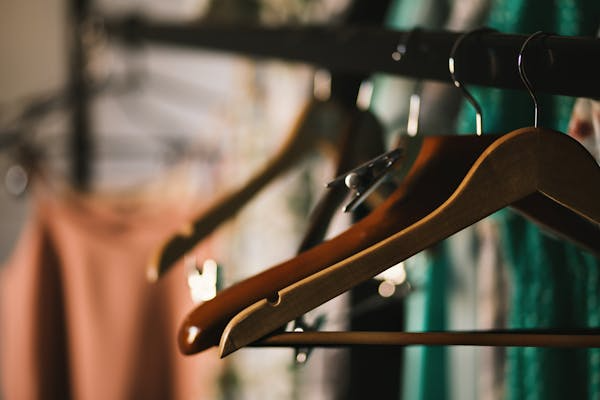 Clothes hangers on a clothes rack. 