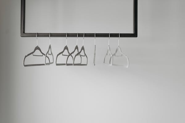 Clothes hangers on a pipe. 